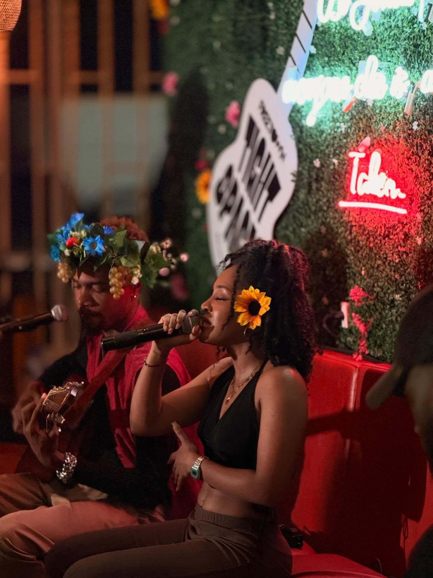 Vocalists performing for a crowd inside 5AM Club Coffee